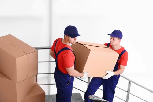 Removal team navigating stairs during a Paddington flat move