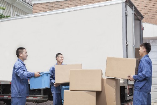 Moving boxes and furniture prepared for a home move in Paddington