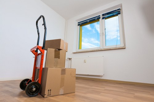 Packed office equipment and labelled boxes prepared for a Paddington move