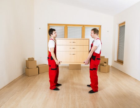 Staff member using lifting technique and PPE during a move